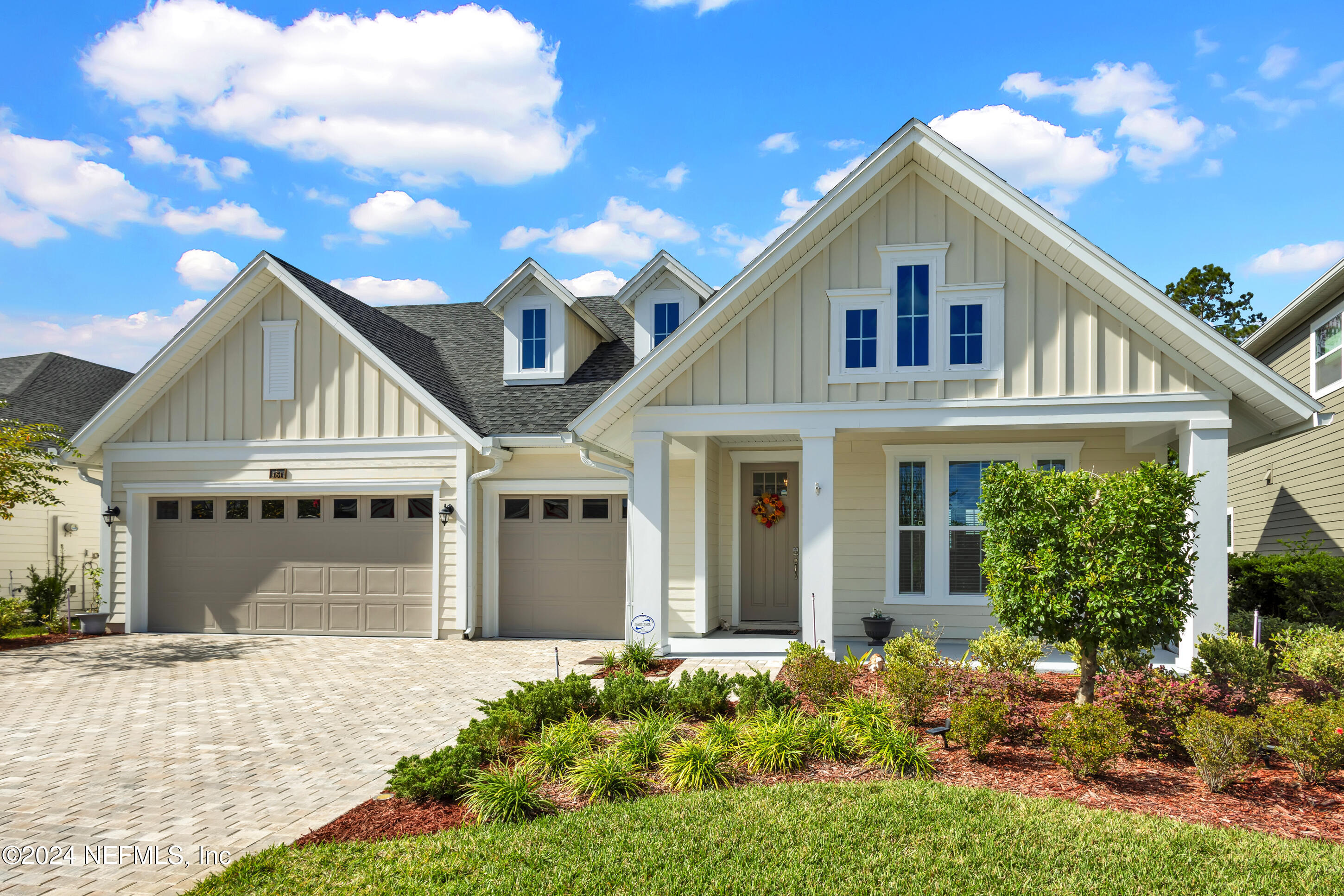 a view of a white house with a yard