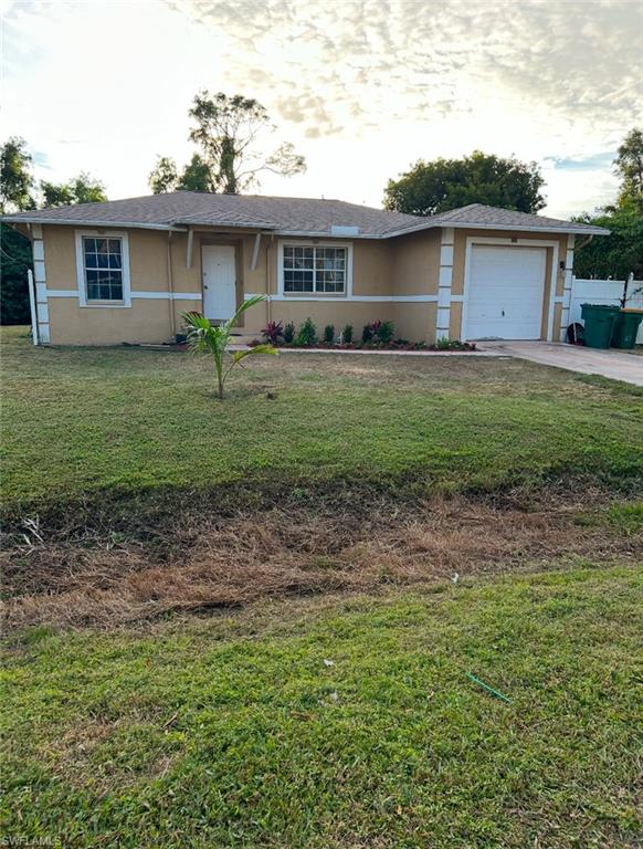 a front view of house with yard and green space