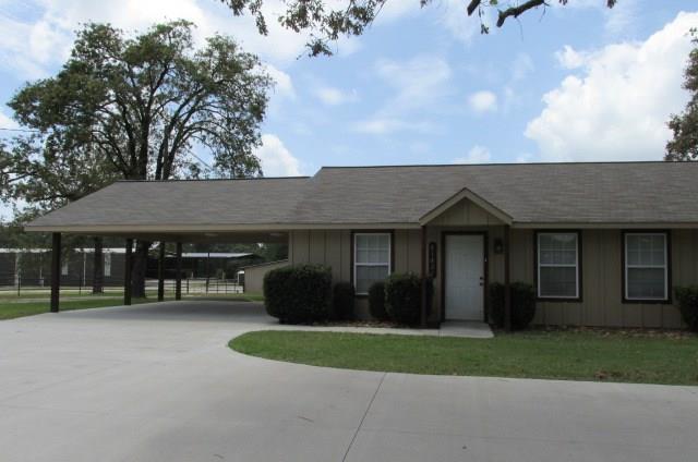 Front View of Duplex with 2 car carport & concrete Driveway