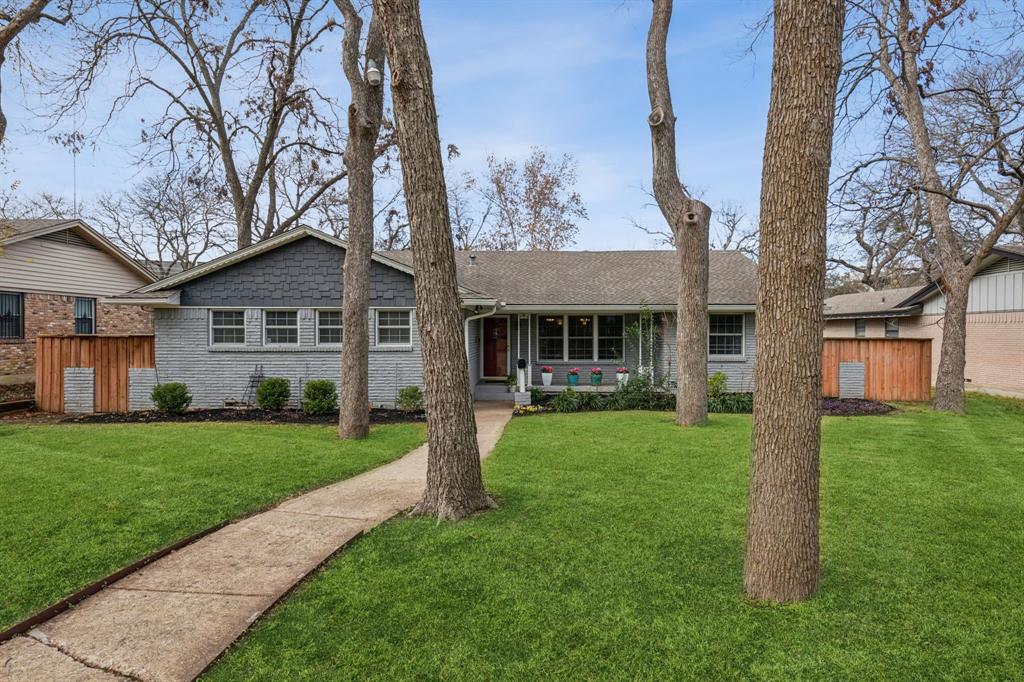 a front view of a house with a yard and porch