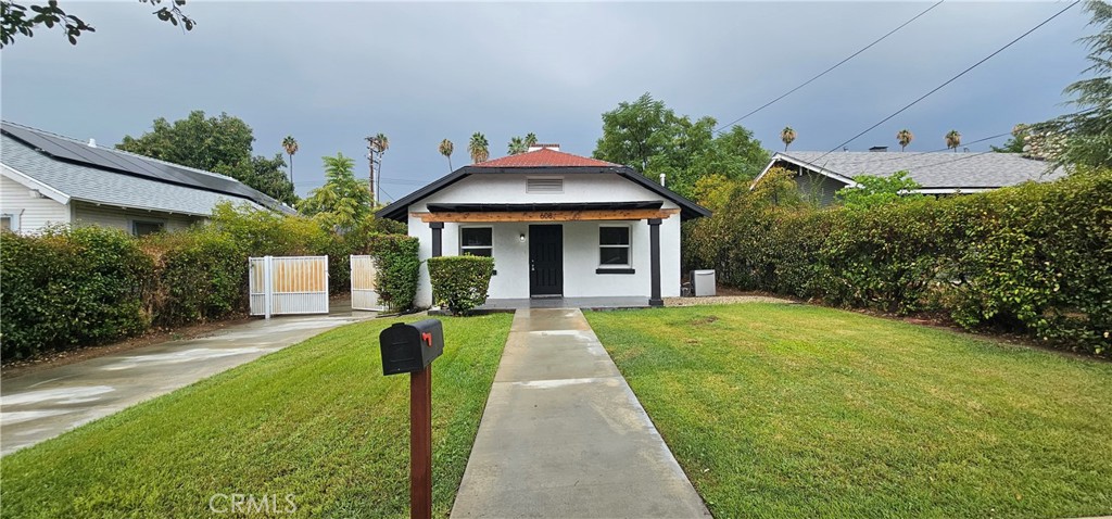 a front view of a house with yard and green space