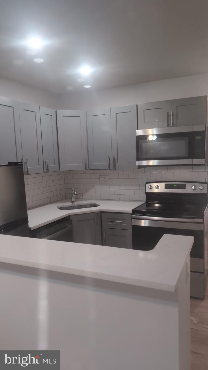 a kitchen with a stove and white cabinets