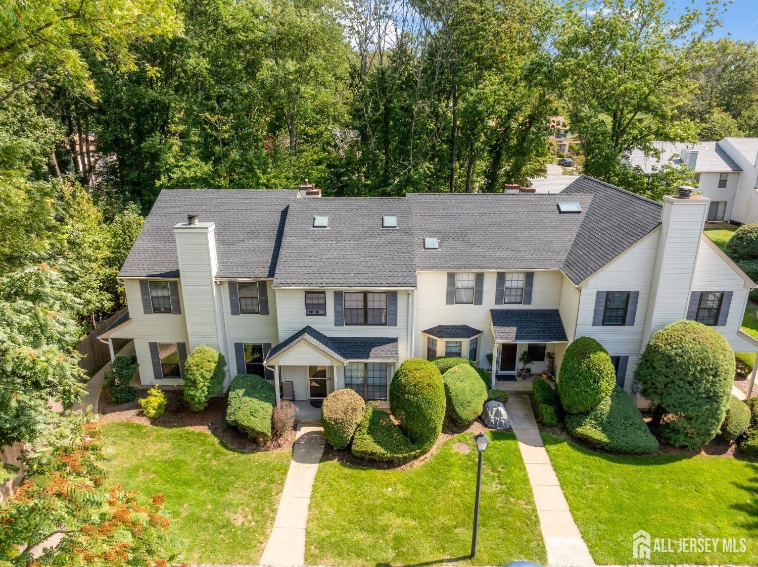 a aerial view of a house with a yard and a garden