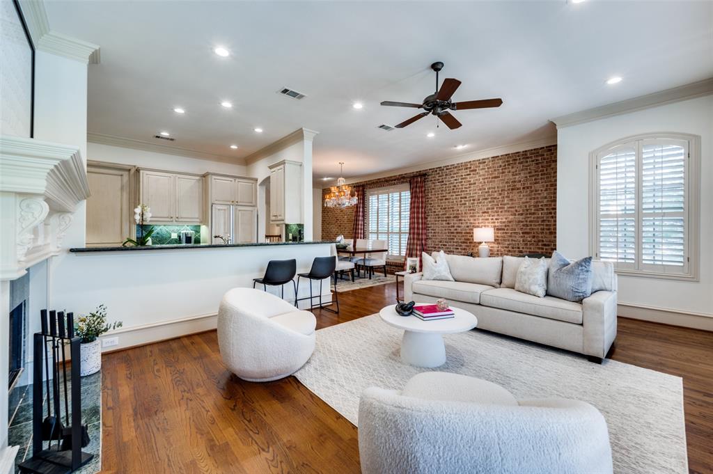 a living room with furniture kitchen view and a large window