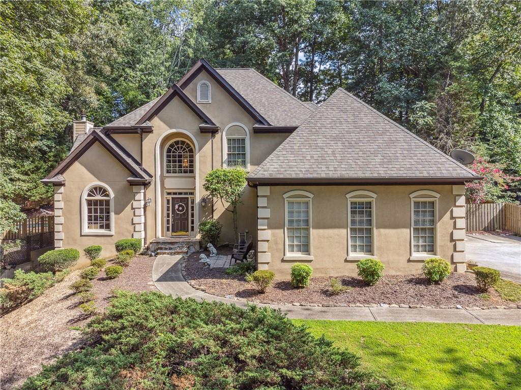 a front view of a house with garden