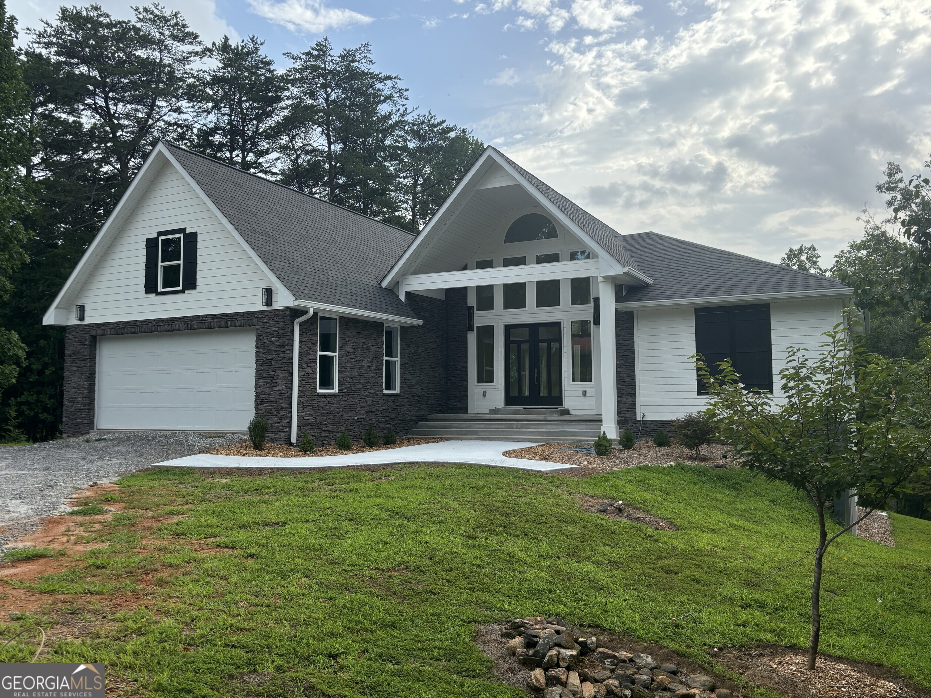 a front view of a house with a yard and garage