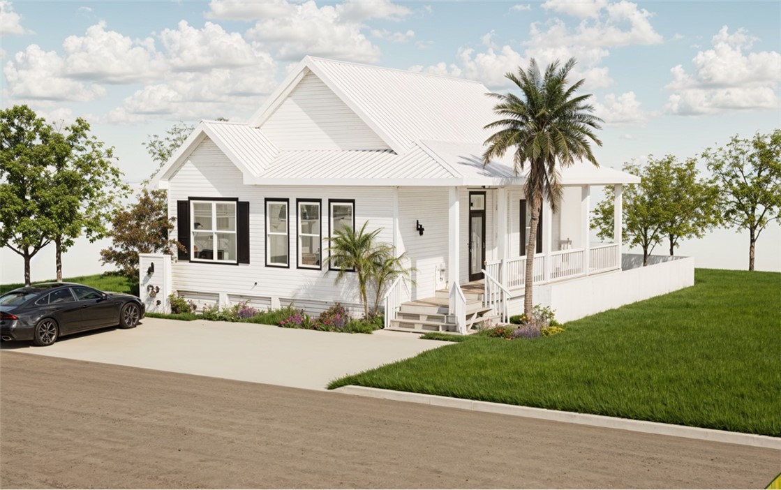 a front view of a house with a yard and potted plants