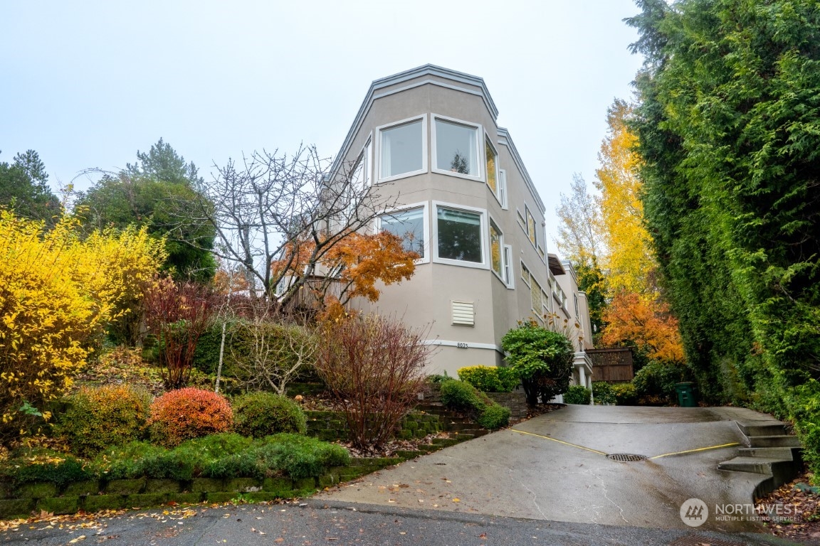 a front view of a house with a yard and trees