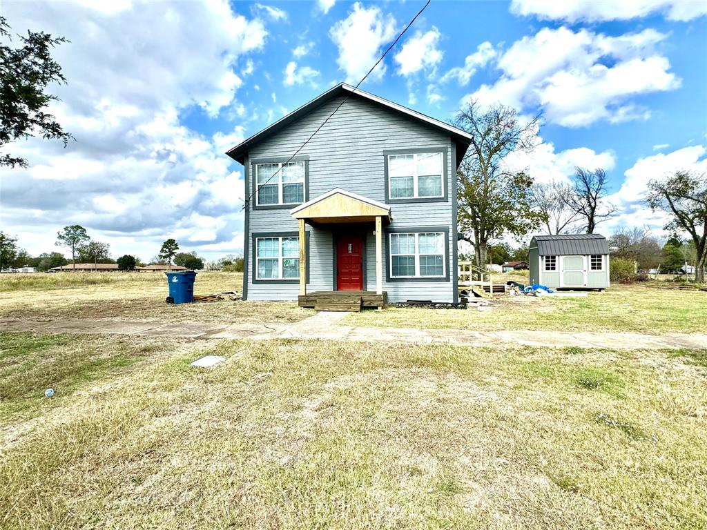 a view of a house with a yard and garage