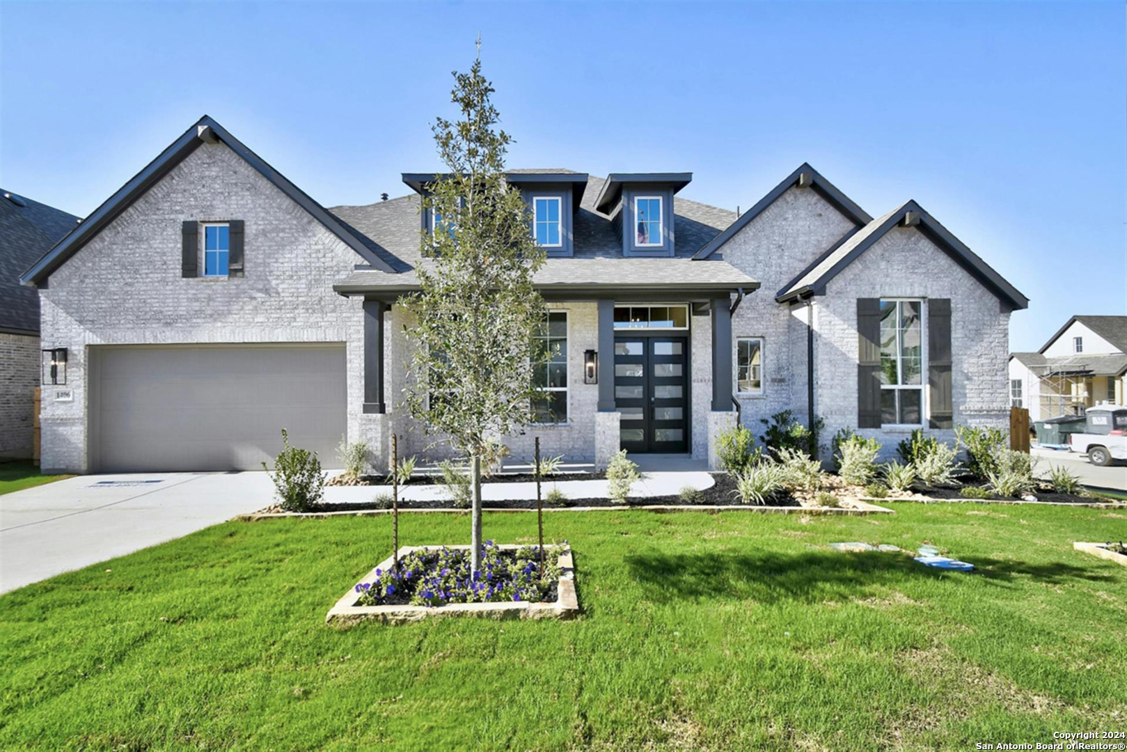 a front view of a house with a yard and garage