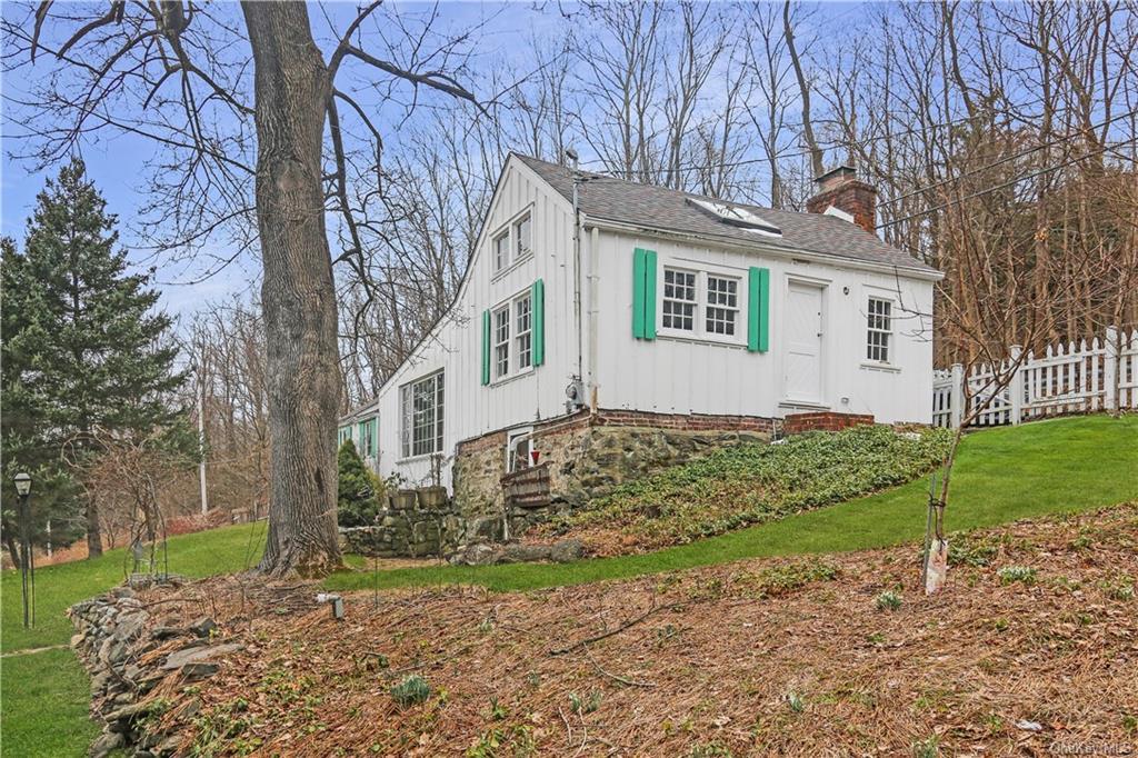 View of side of property with a yard