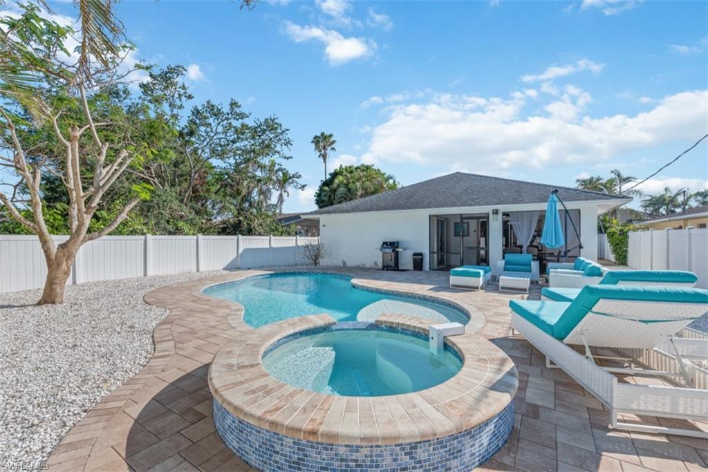 a view of a house with swimming pool and sitting area