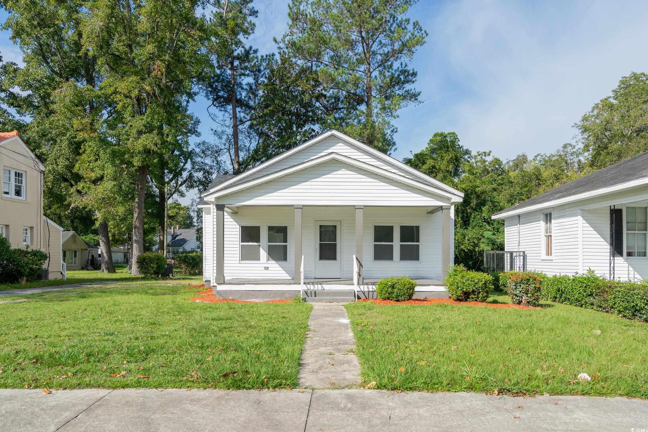 Bungalow-style house featuring a front lawn and a