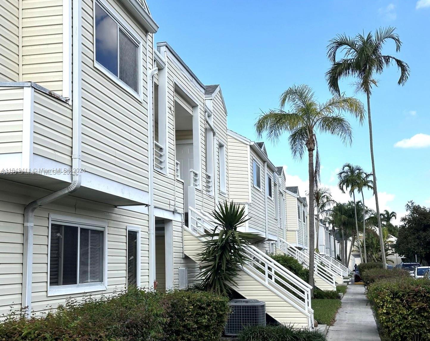 a view of a house with a palm tree