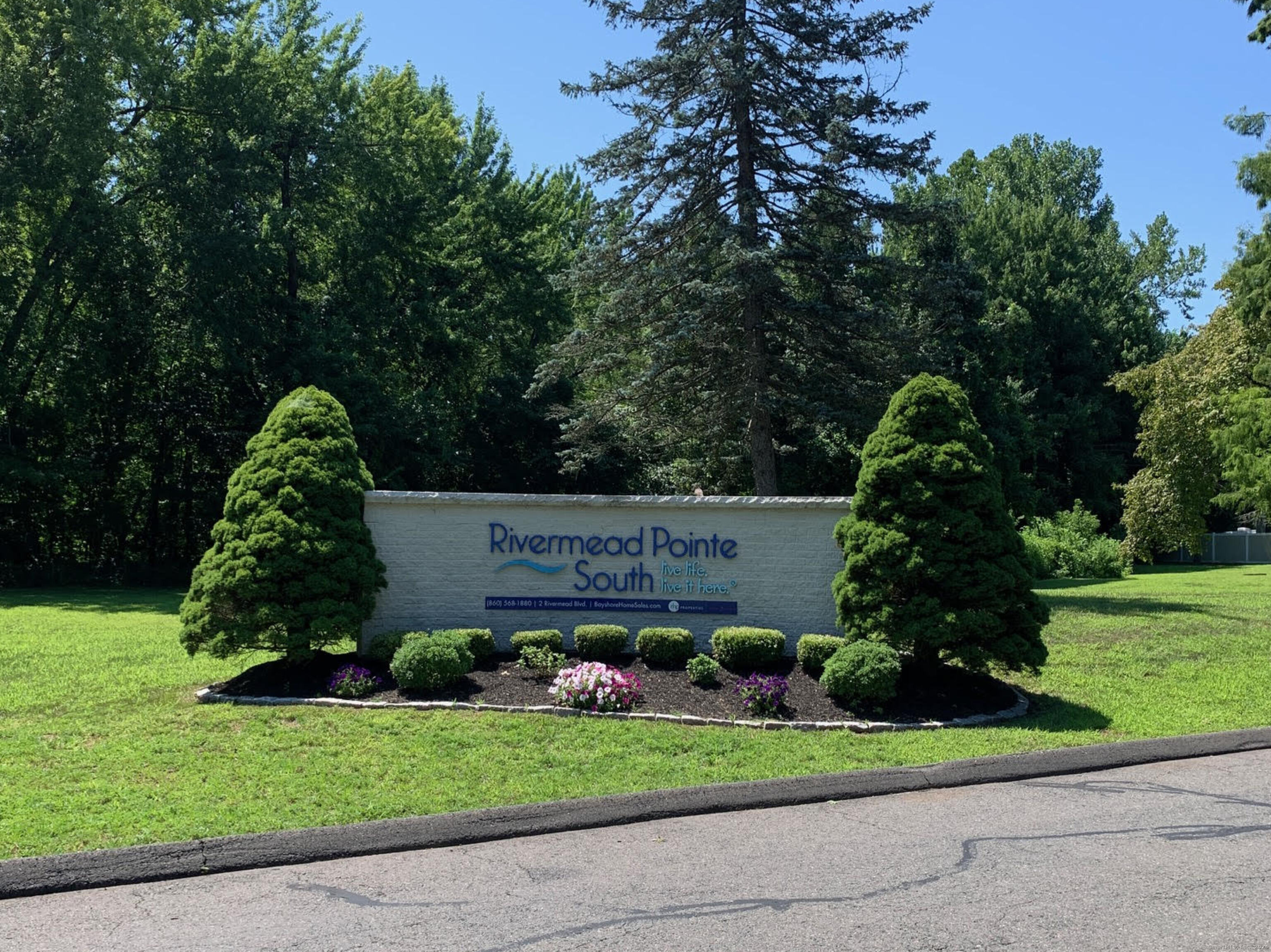 a view of a sign board and a yard