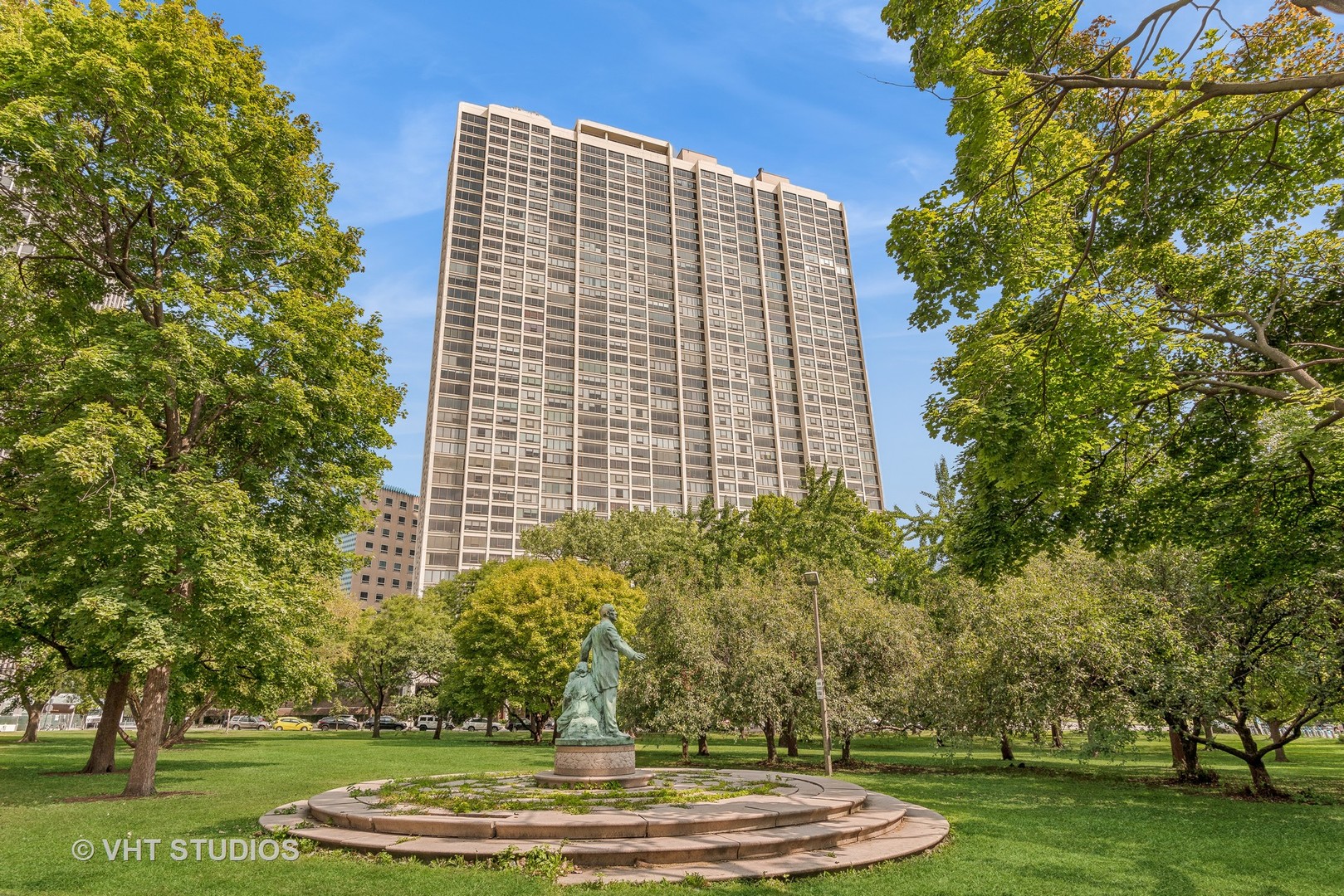 a front view of a building with trees