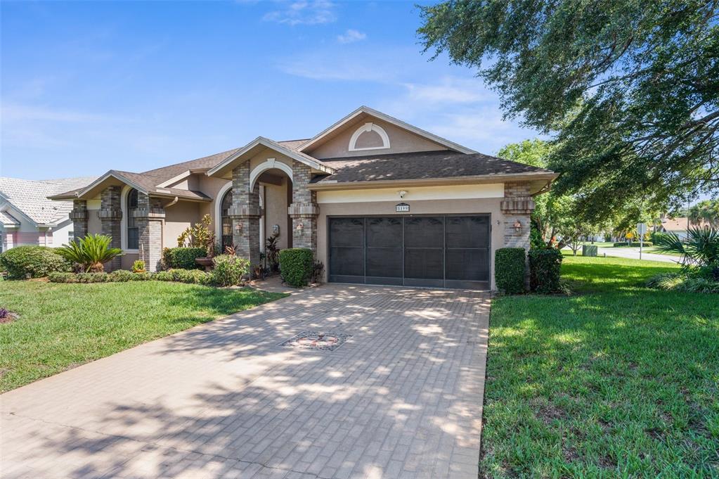 a front view of a house with a yard and garage