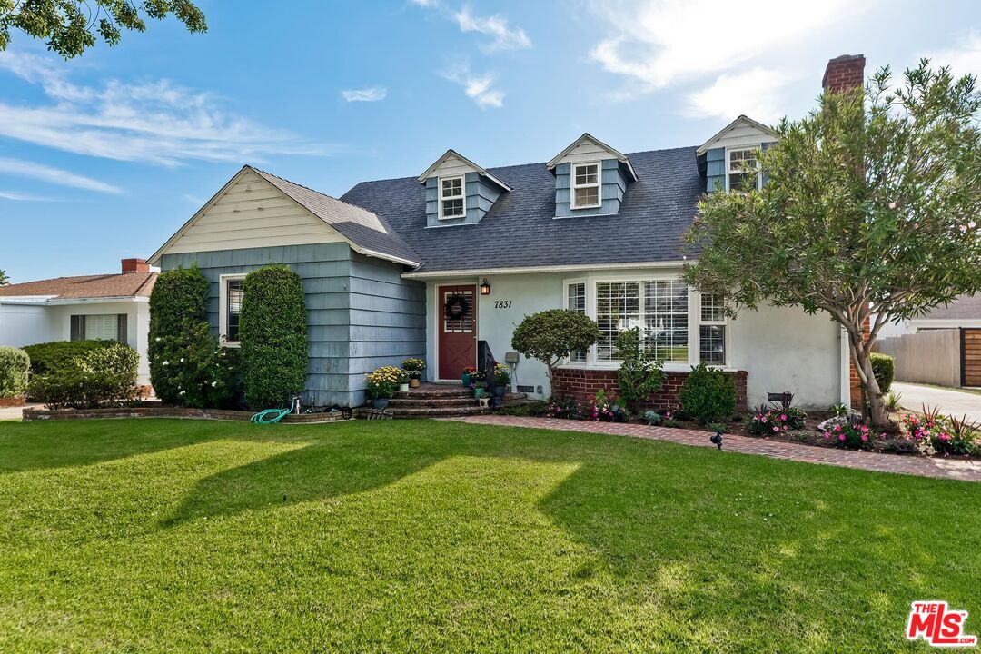 a front view of a house with a garden and plants