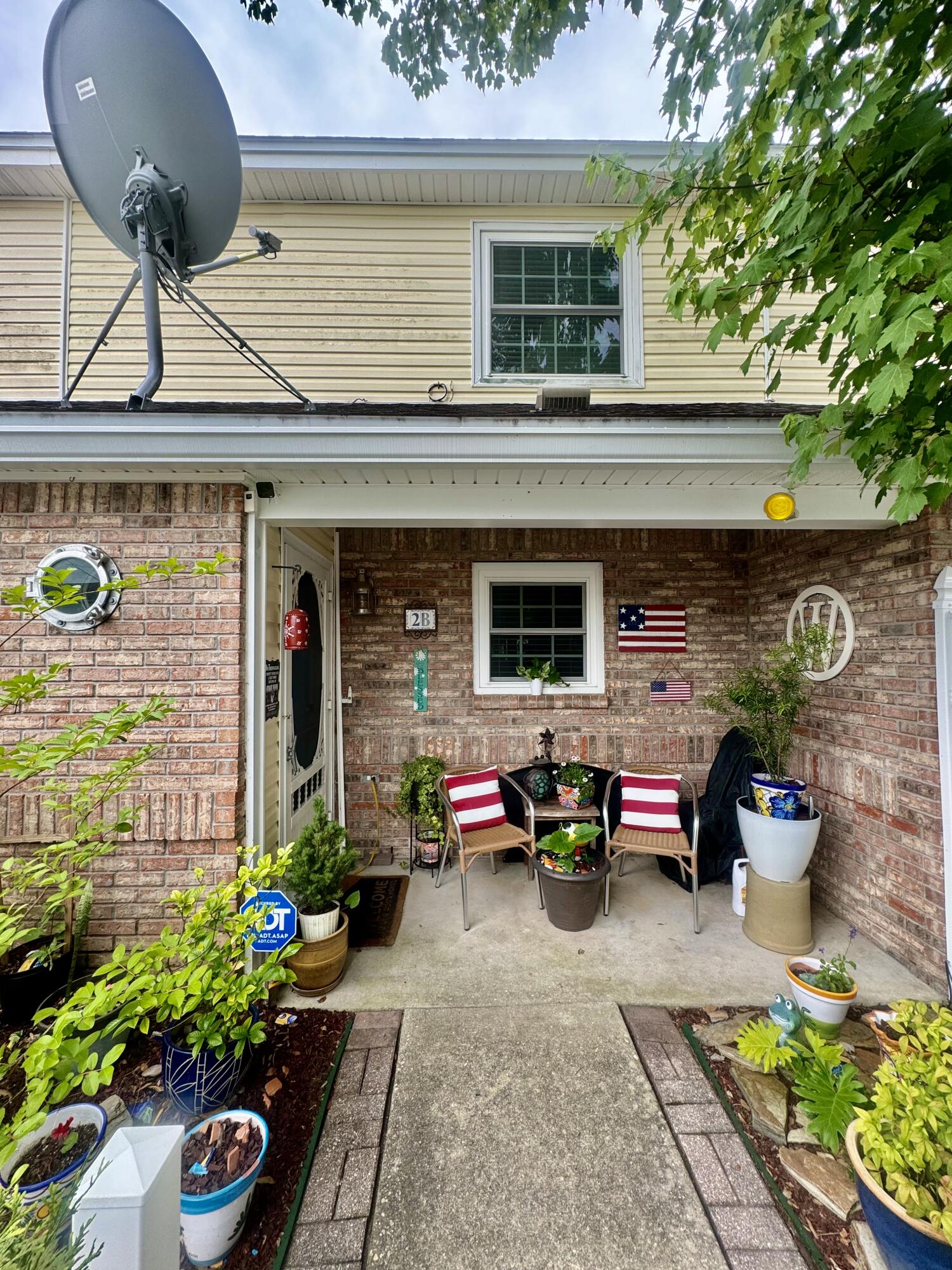 a front view of a house with outdoor seating