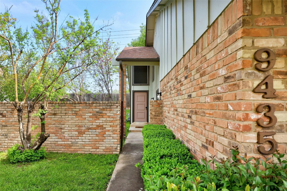 a view of a pathway of a house with a yard