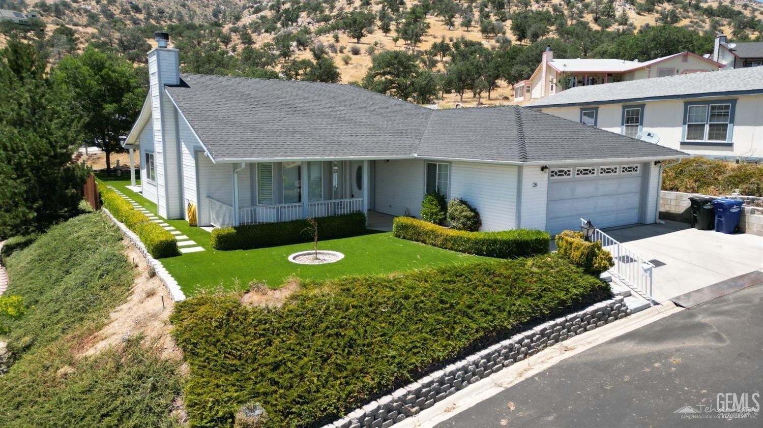 a view of a house with a garden and plants