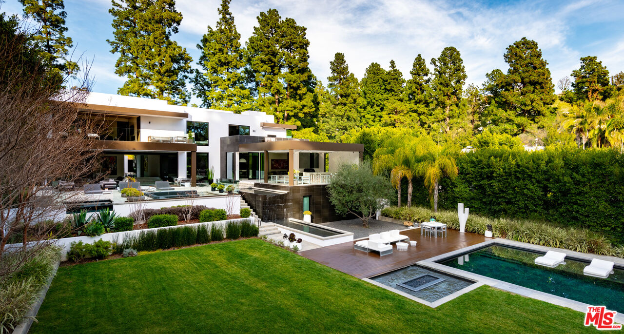 a view of a patio with couches table and chairs with garden view