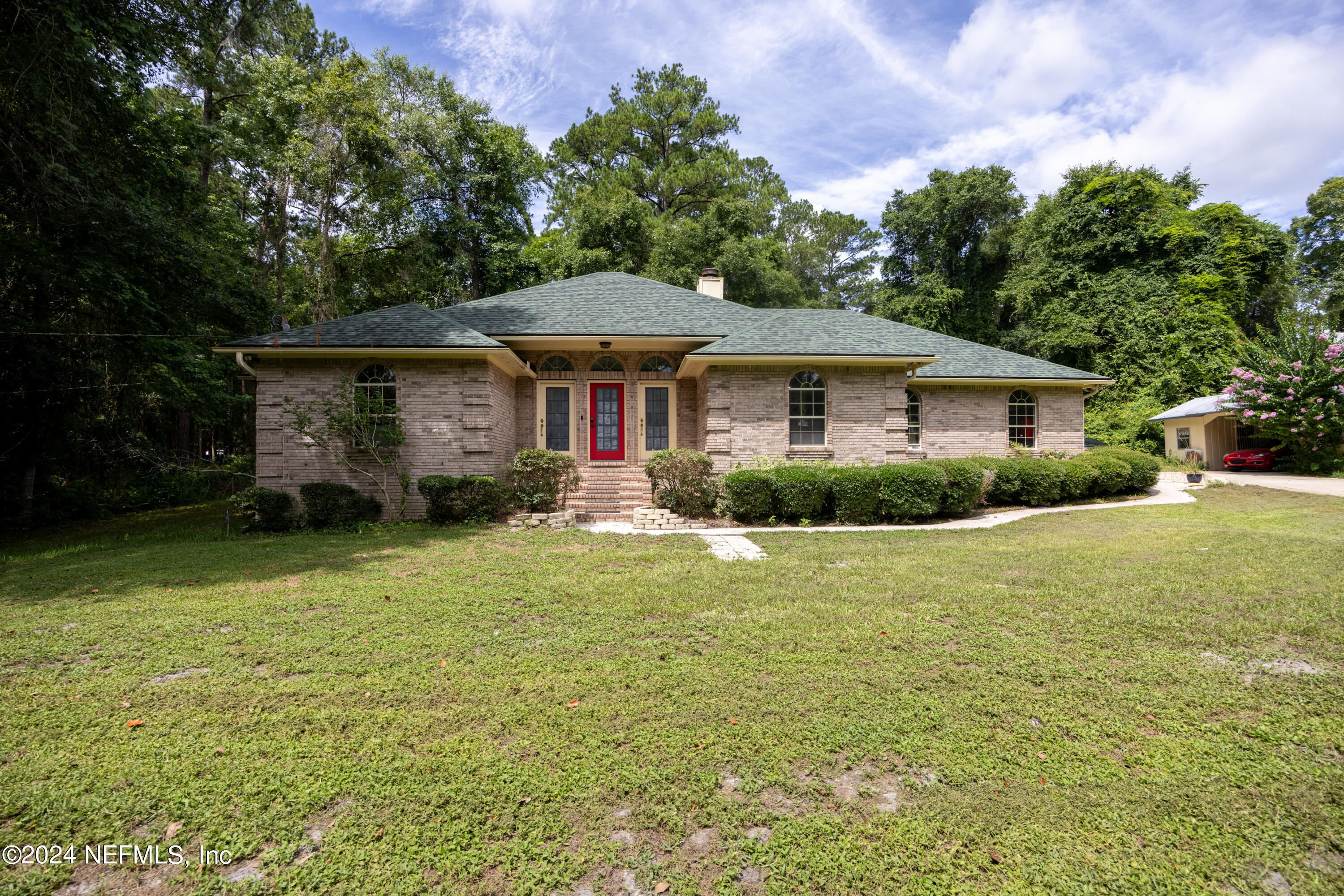 a front view of a house with a garden