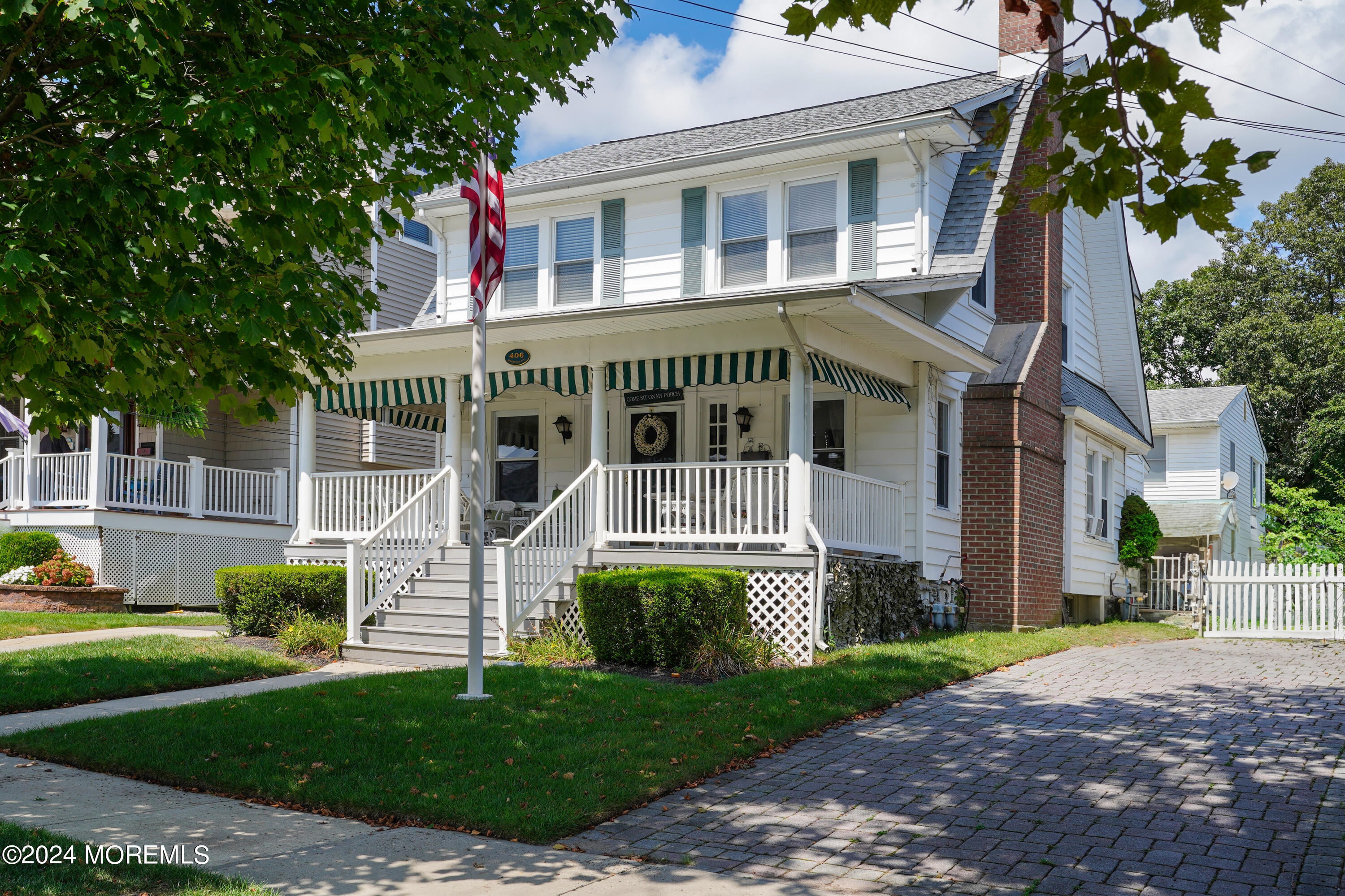 a view of house with a yard and potted plants