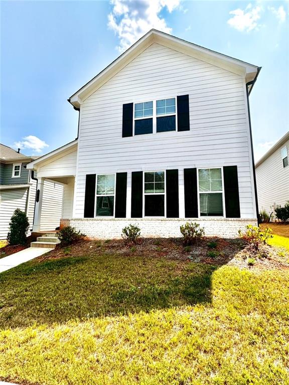 a front view of a house with a yard