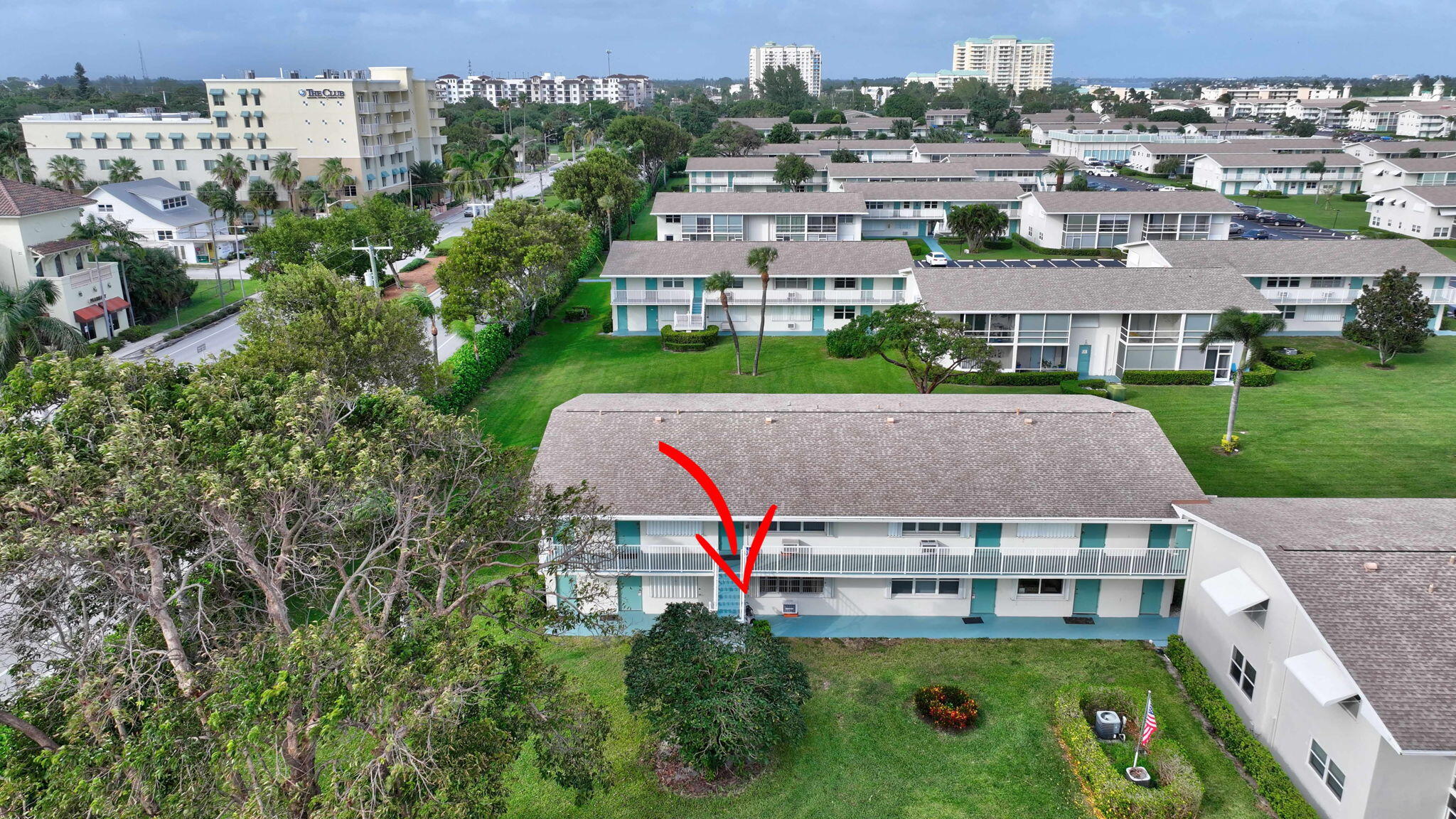 an aerial view of multiple houses with a yard