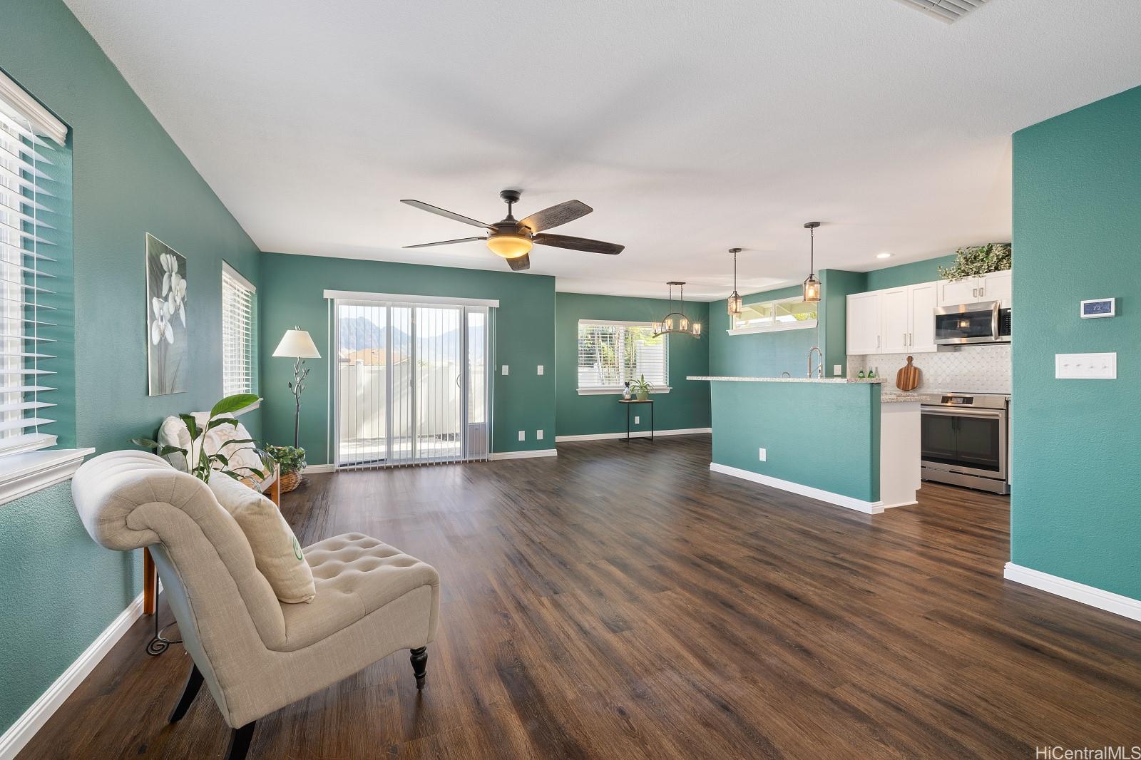 a living room with furniture and a wooden floor