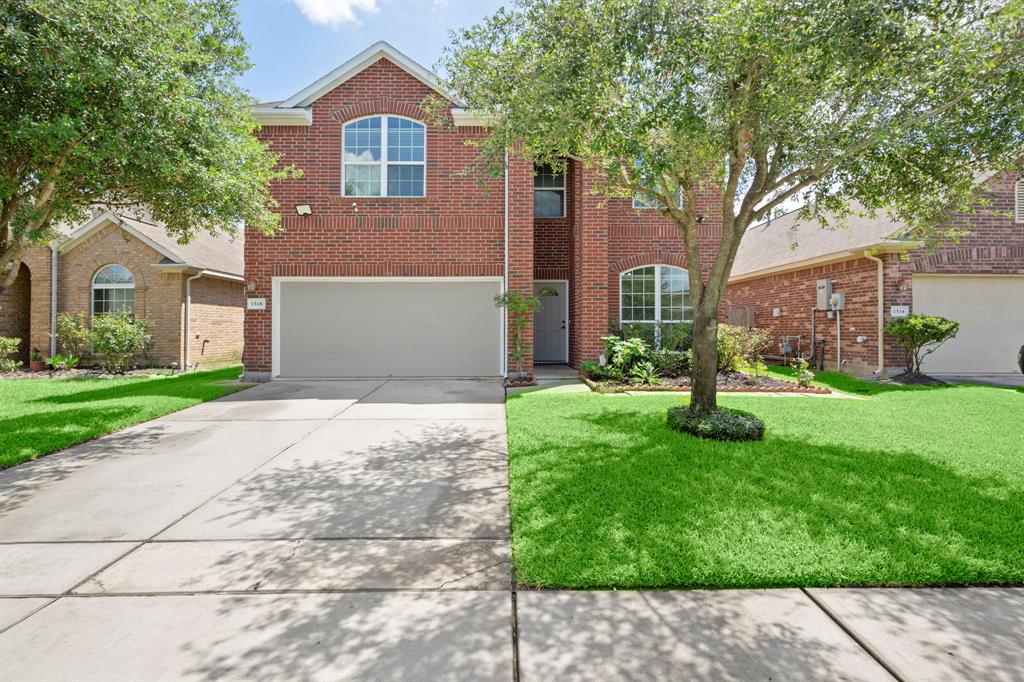 Welcome to your inviting two-story home, featuring a beautifully landscaped entryway that sets the stage for warmth and sophistication within.