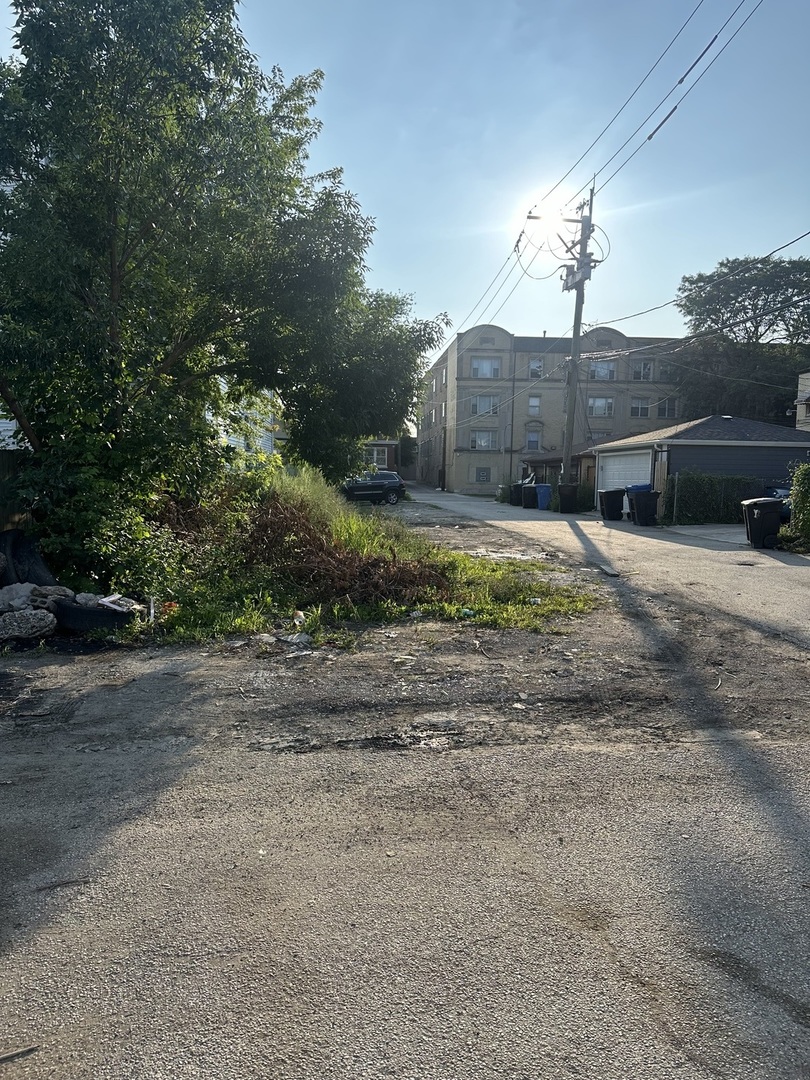 a view of a house with a yard and pathway