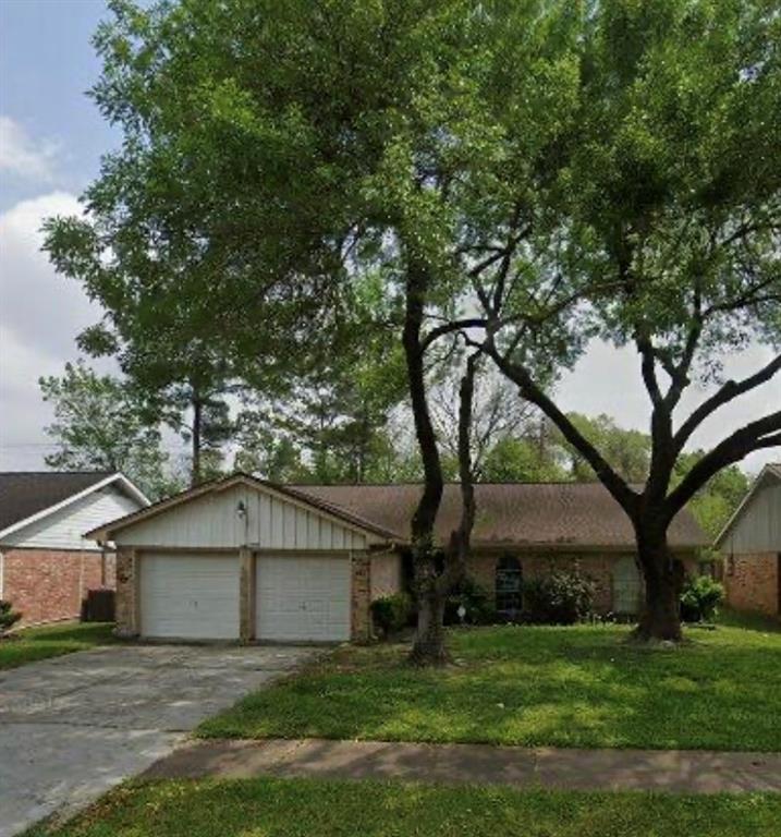 a house that has a tree in front of a house