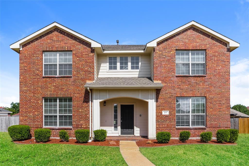 front view of a house with a yard