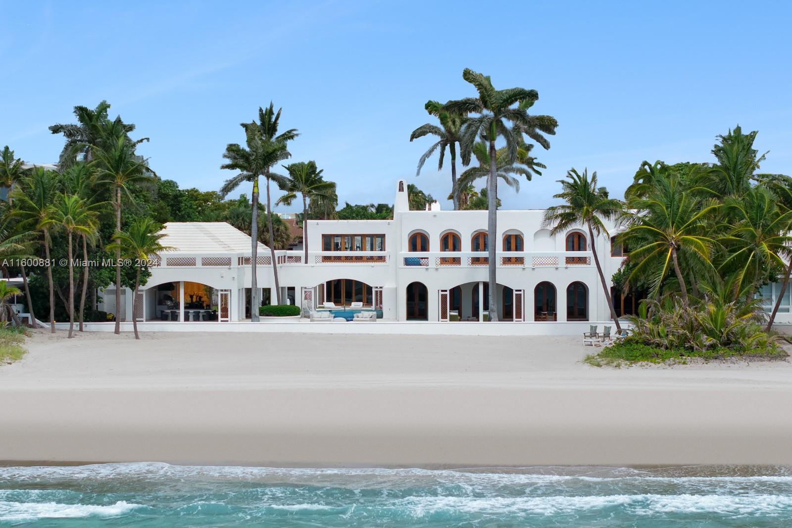 a view of multiple houses with palm trees