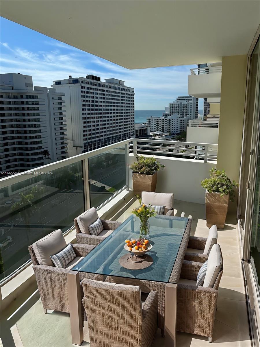 a view of a balcony dining table and chairs