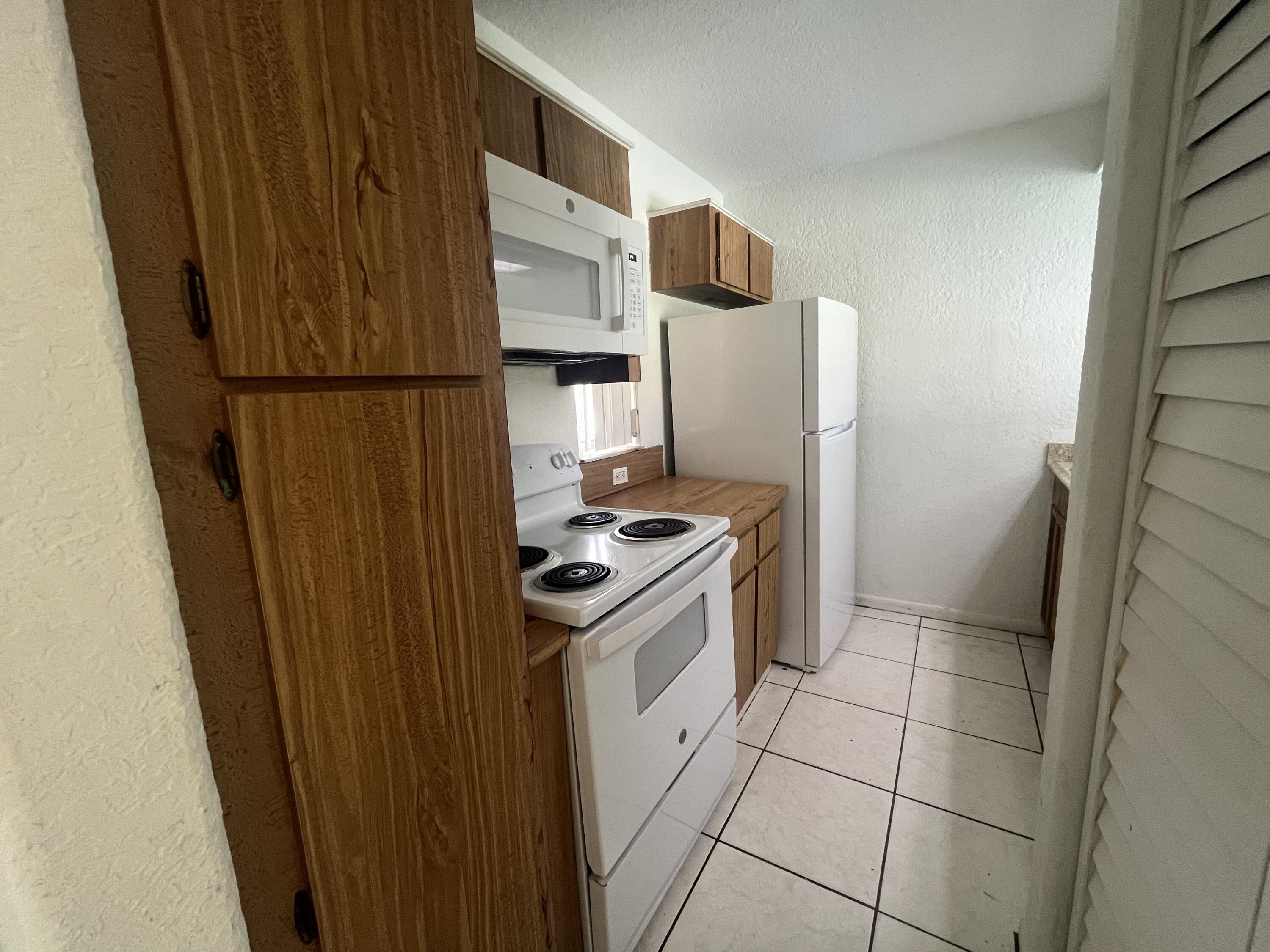 a kitchen with a stove top oven and cabinets