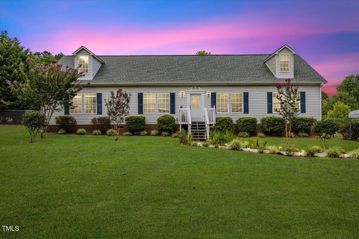 a front view of house with yard and green space