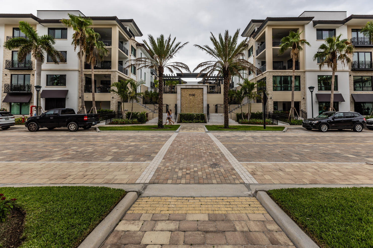 a front view of multiple houses with yard