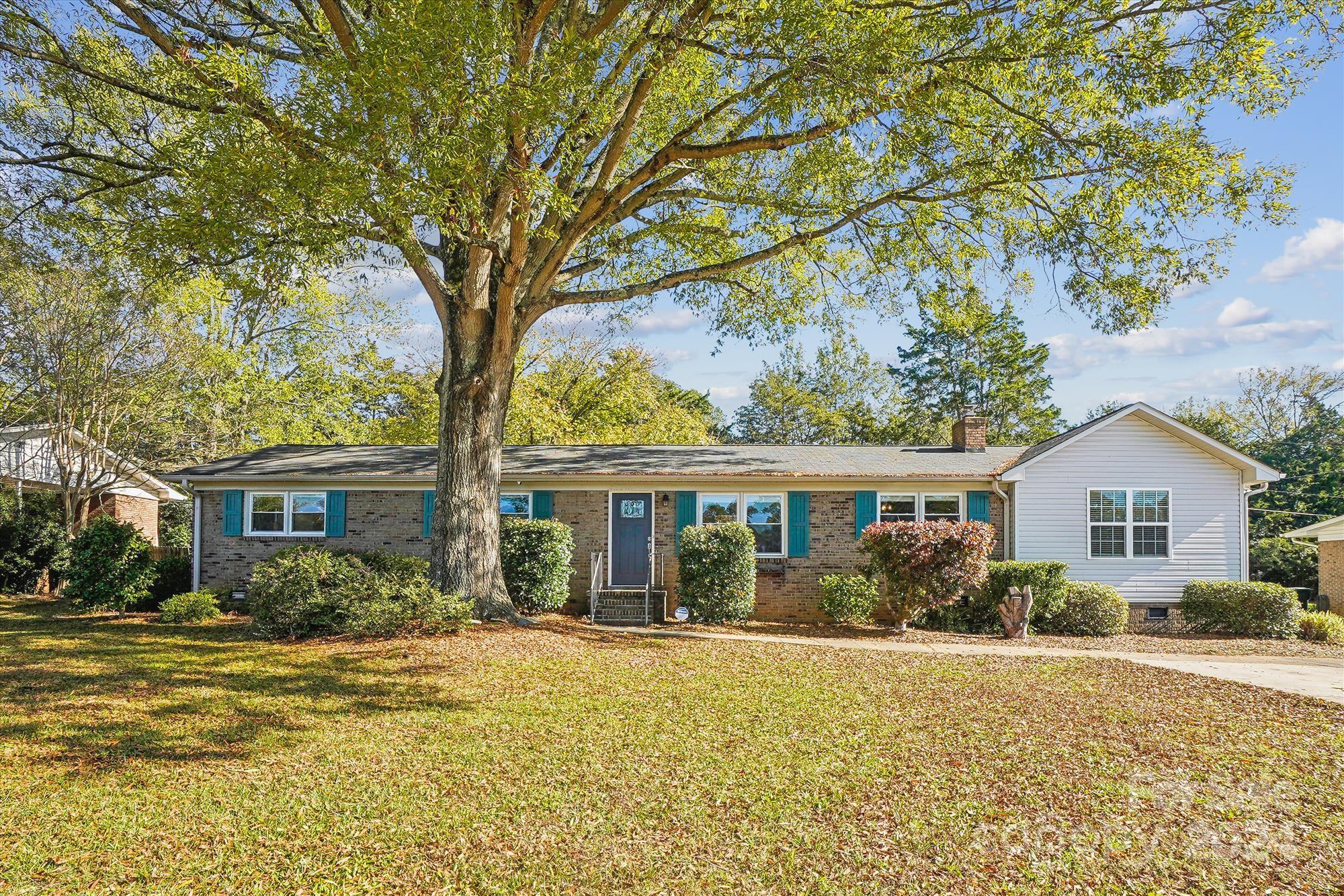 a front view of house with yard and green space