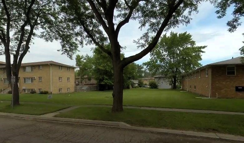 a white house that has a tree in front of it