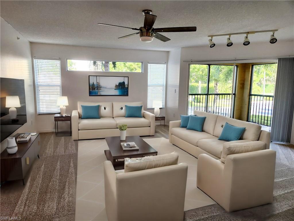 Living room featuring track lighting, ceiling fan.  Virtually staged for information purposes