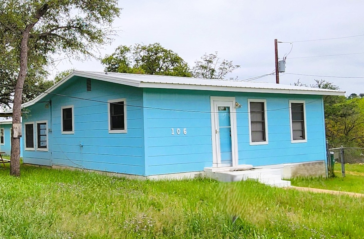 a view of a house with a backyard