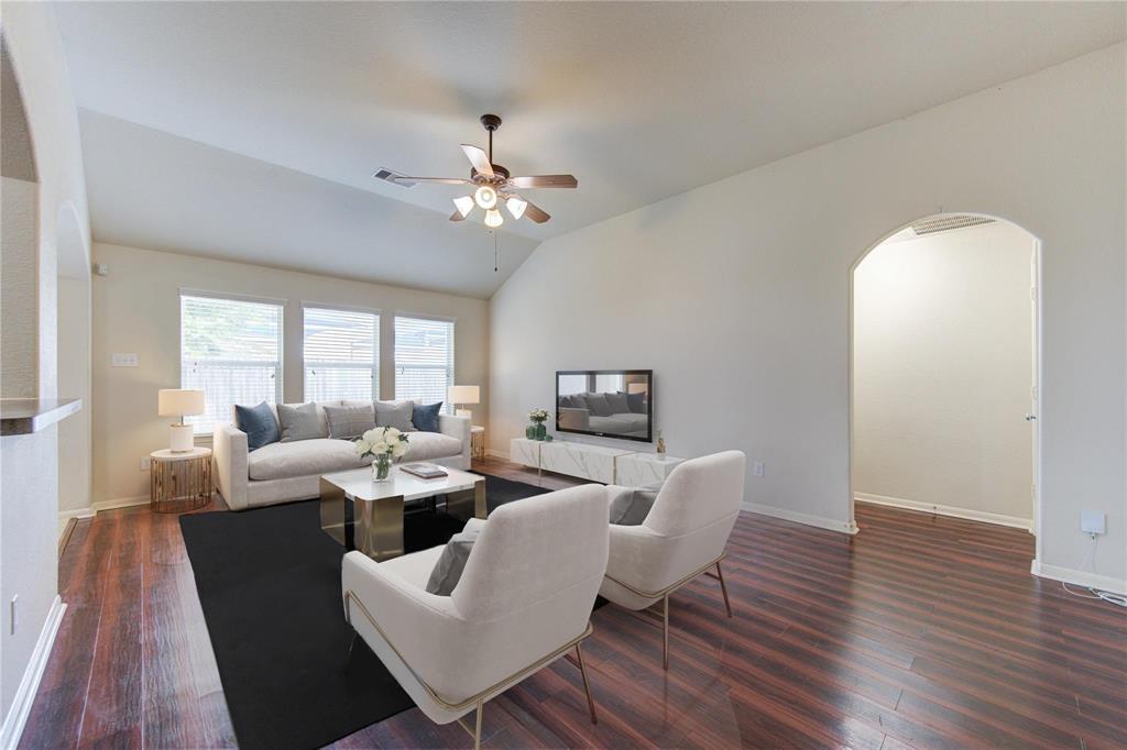 a living room with fireplace furniture and a wooden floor