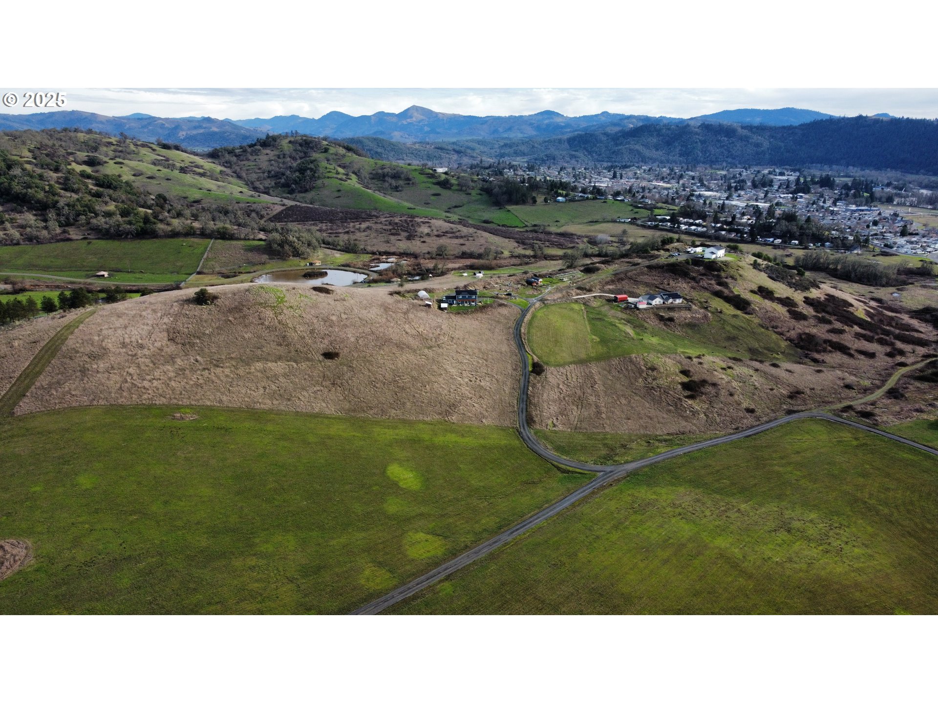 a open area with mountains in the background