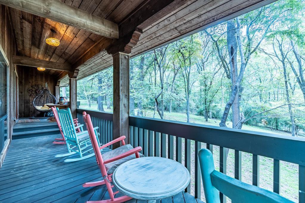 a view of a chairs and table in the balcony