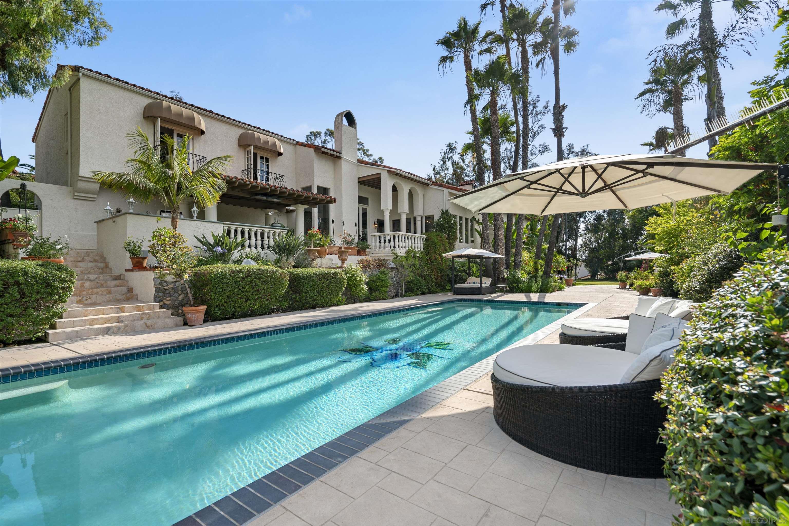 a view of a house with backyard sitting area and garden