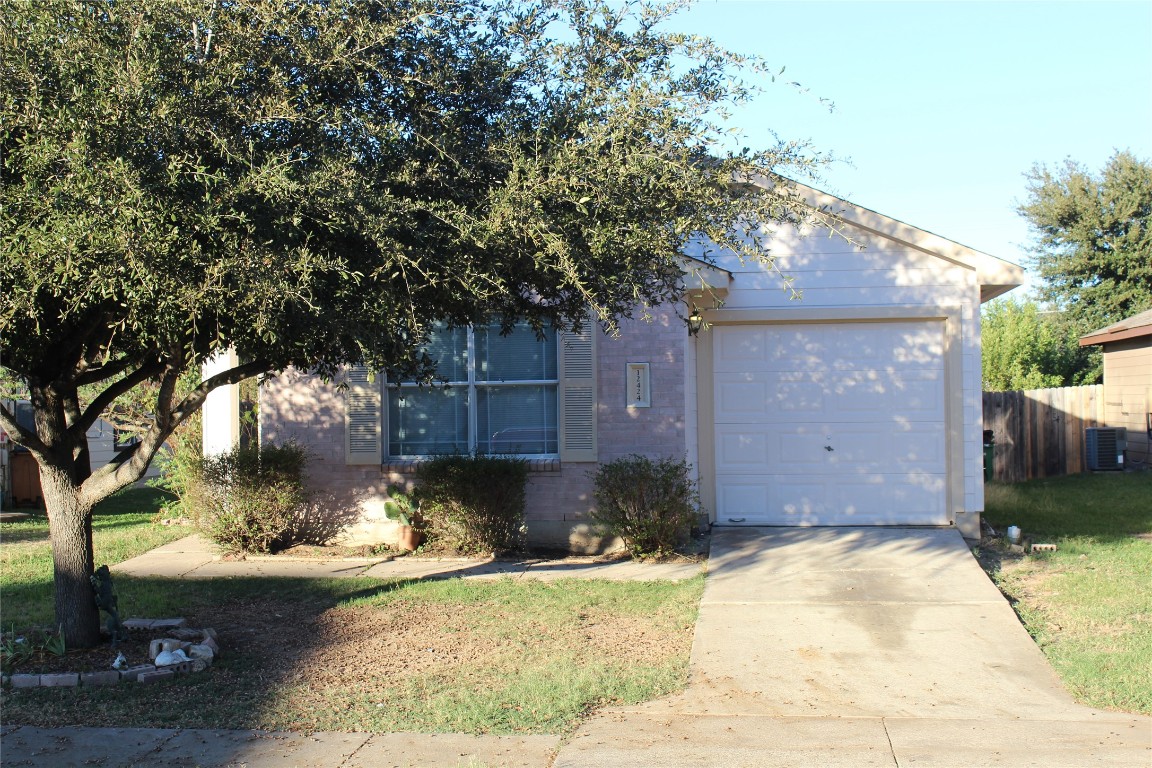 a front view of a house with a yard and a garden