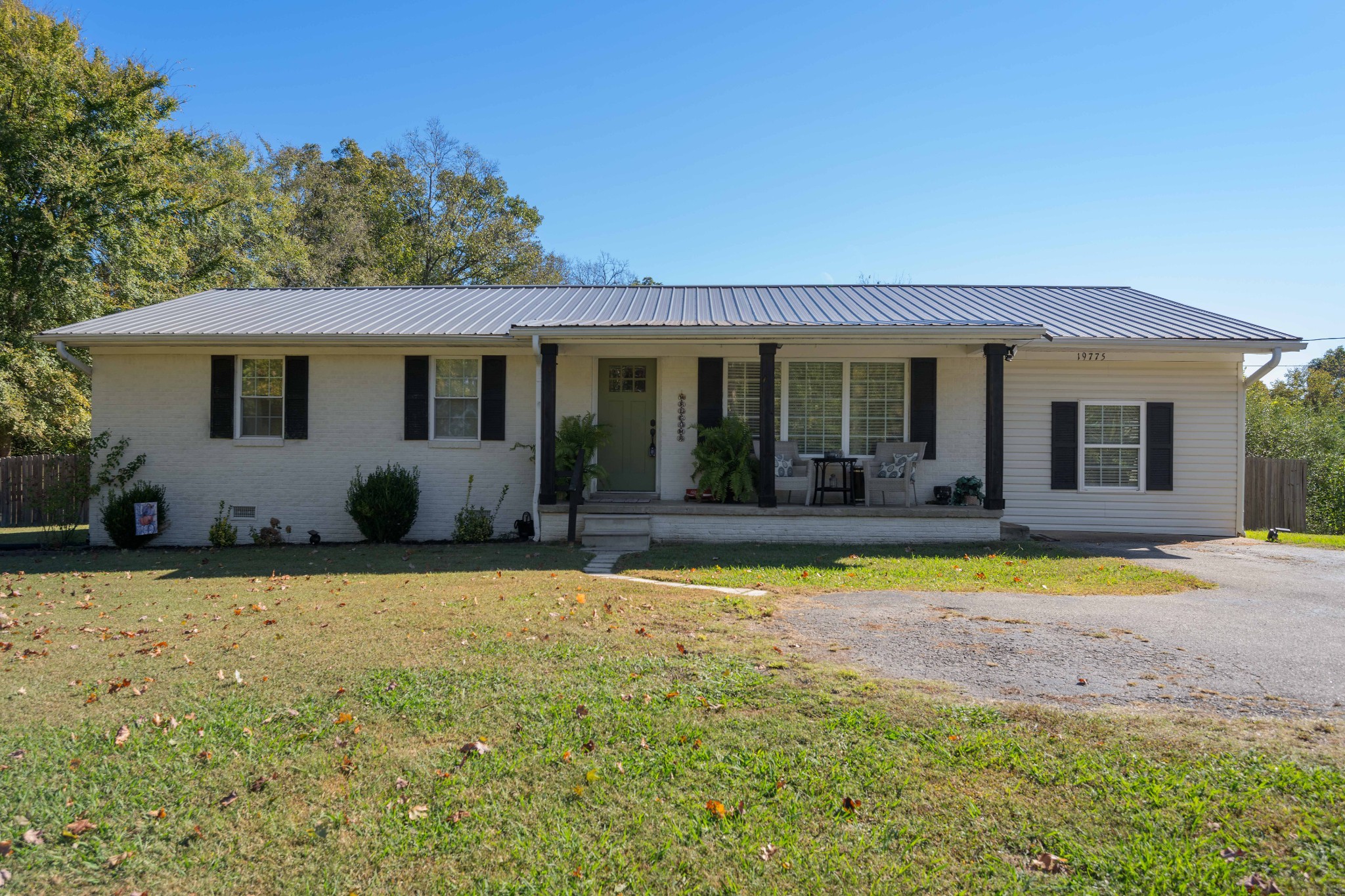 a view of a house with swimming pool and a porch